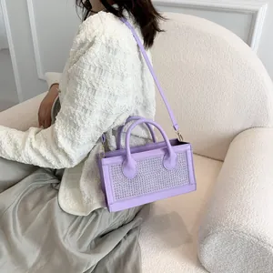 Detail of lavender rhinestone handbag with silver crystals and adjustable shoulder strap