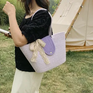 Handmade purple woven straw tote bag with a lace bow and magnetic flap for beach vacations