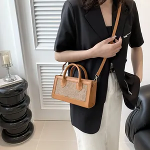 Brown rhinestone handbag styled with a black blazer and white skirt for a chic look