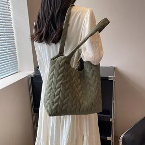 Detail view of army green quilted cloud tote bag featuring unique textured pattern
