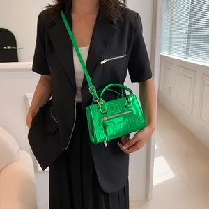 Neon green crocodile embossed mini handbag with crossbody strap and silver hardware details