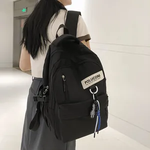 Sac à dos scolaire noir minimaliste à grande capacité avec charm en damier