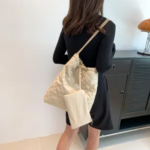 Beige quilted tote bag with gold chain strap and matching mini pouch for women