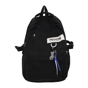 Sac à dos minimaliste en nylon noir avec pendentif ours et grande capacité pour étudiants