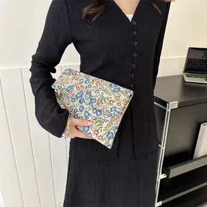 Vintage floral jacquard envelope clutch bag with blue and red patterns and wristlet strap