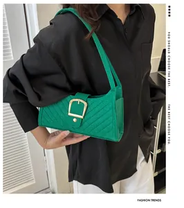 Detail view of grass green felt shoulder bag with chevron stitching and golden square clasp