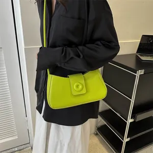 Minimalist bright green crossbody bag with doughnut buckle and contrast stitching style
