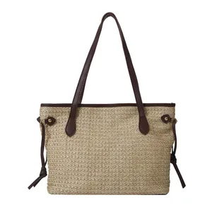 Grande borsa tote in paglia intrecciata beige con manici in pelle marrone e coulisse