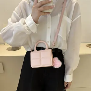 Pink minimalist checkered small square bag with plush pendant and thin strap