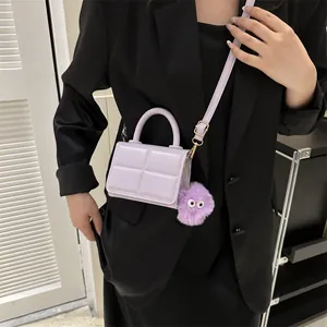Chic purple plaid mini crossbody bag with round handle and plush monster charm
