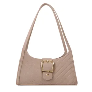 Pink felt shoulder bag with diagonal quilting and decorative gold metal buckle