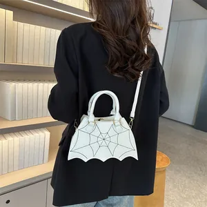 Detailed view of white PU leather crossbody bag with black spider web stitching and wave edge