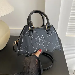 Detail of gothic spider web stitching on black PU leather bag with bat wing shaped base