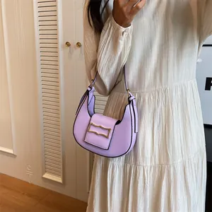 Detail of lavender crescent shoulder bag featuring a vintage gold metal buckle on leather