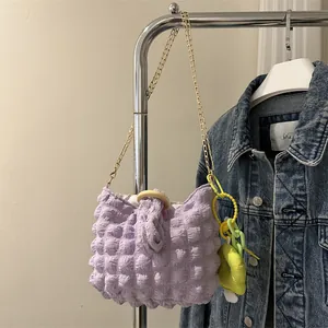 Detail of lavender popcorn fabric bag with gold chain and neon star charm on hanger