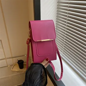 Detail of fuchsia PU leather mini crossbody bag with sleek gold metal bar accent
