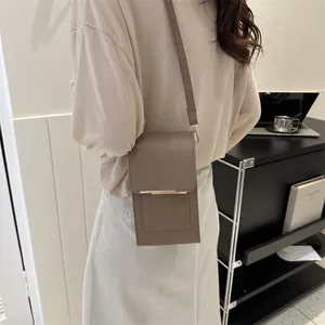 Minimalist brown matte faux leather crossbody bag with elegant gold metal bar accent