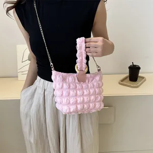 Pink quilted bubble fabric shoulder bag with gold chain strap and textured soft handle
