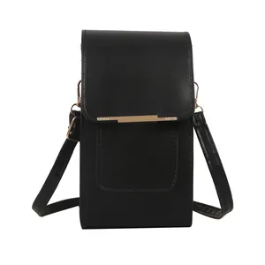 Minimalist black PU leather crossbody phone bag with gold metal trim on white background