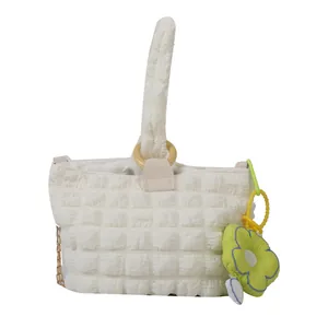 Chic bubble texture cream handbag with floral charm and padded shoulder strap
