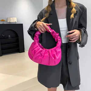 Detail of rose pink ruched cloud bag with high-shine synthetic leather finish