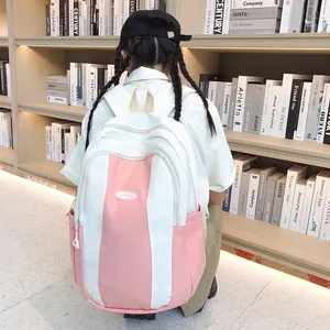 Detail of color-block pink and beige school backpack with Fashion patch in library setting