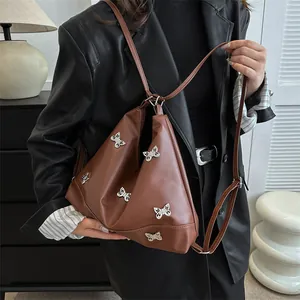 Brown faux leather triangle tote bag with silver butterfly charms and slim straps