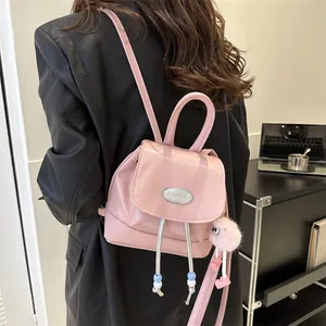 Pink vintage PU leather mini backpack with metal logo and plush ball keychain charm