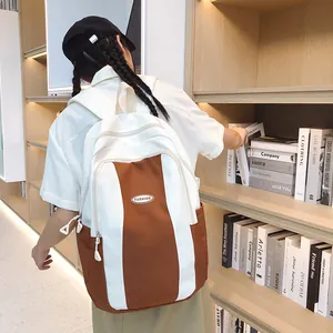 Detail of color-block backpack with large main compartment and front pocket in library