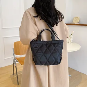 Quilted black tote bag for women with a sleek diamond pattern and dual carrying straps