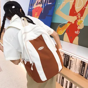 Detail view of large capacity color-block canvas backpack in white and caramel brown