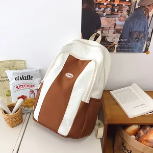 Detail of a minimalist brown and white contrast color backpack in a lifestyle setting