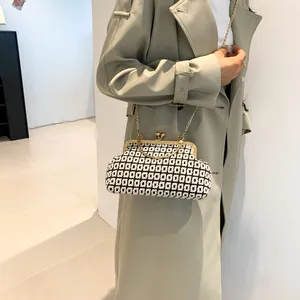 Retro woven chain bag with black and white geometric pattern and gold ring handle