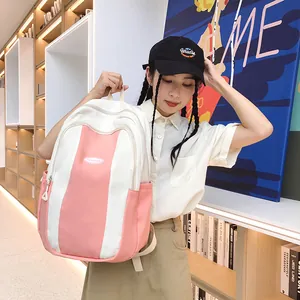 Pink and white contrast canvas backpack with FASHION logo in a library setting