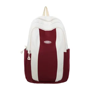 Minimalist high-capacity backpack with red and white color blocking and front pocket