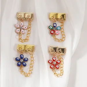 Detailed close-up of Italian charm flower pendants with enamel evil eye patterns