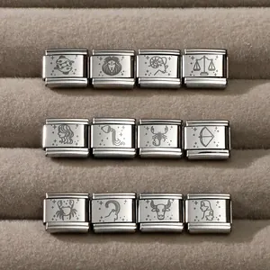 Macro detail of twelve zodiac signs engraved on stainless steel modular charm links