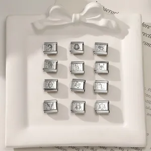 Macro view of twelve zodiac signs laser-etched on silver modular Italian charm bracelets