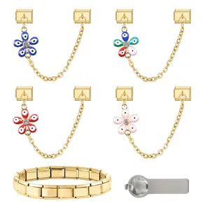 Detail of gold Italian charm bracelet with evil eye floral links and assembly tool