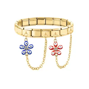 Detail of gold stainless steel Italian charm bracelet with floral devil eye charms