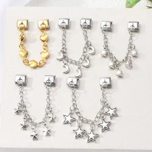 Close-up of Italian style bracelet links with heart, moon and star charms in gold and silver