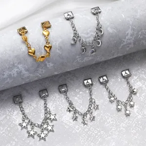 Detail of Italian charm bracelet links featuring gold heart and silver star pendants