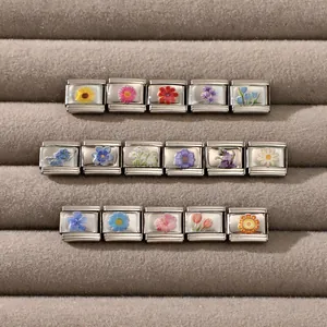 Macro shot of Italian charm links with colorful floral patterns on stainless steel