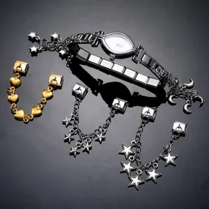 Detail of stainless steel modular bracelet with moon pendant and star chain accessories