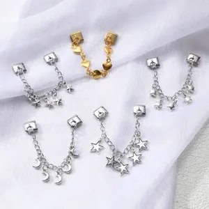 Italian charm bracelet links featuring gold heart and silver star pendants on soft fabric