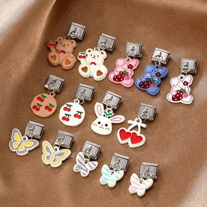Detailed macro view of cute cartoon animal enamel charms on premium satin background