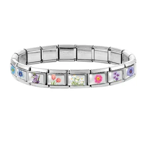 Detailed macro view of modular stainless steel links featuring colorful floral patterns