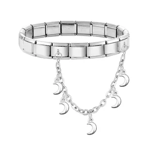 Macro detail of stainless steel modular bracelet with crescent moon charms on a link chain