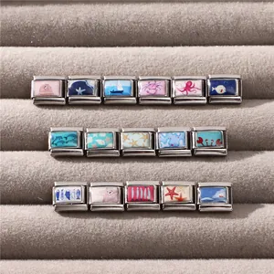 Macro detail of Italian ocean charms with marine animals on silver stainless steel