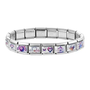 Macro shot of stainless steel modular links with colorful heart and rainbow motifs